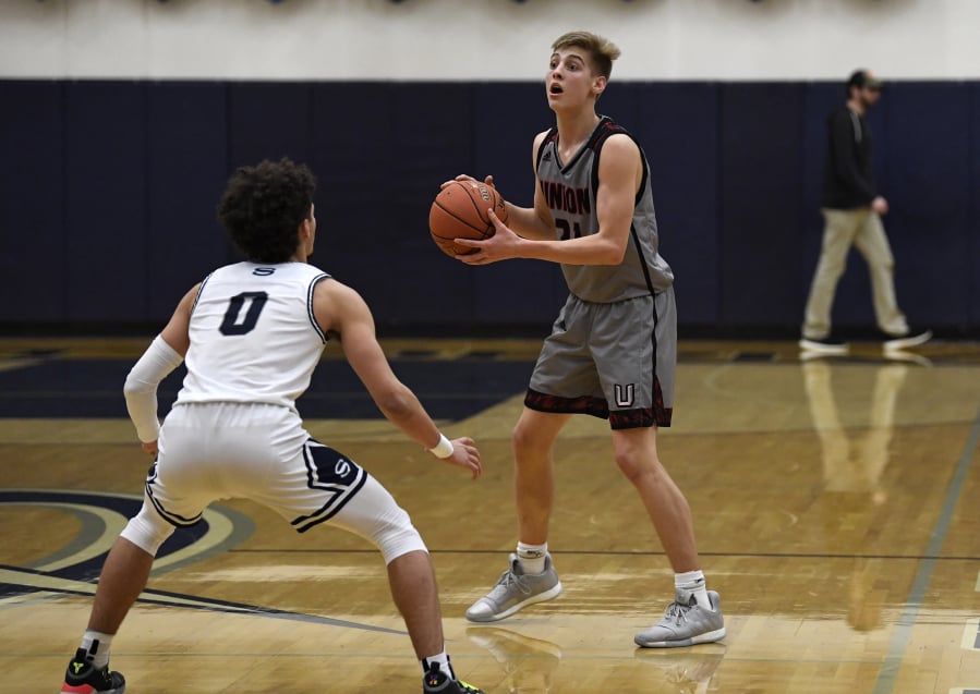 Union’s Tanner Toolson (21) has been described by Union coach Blake Conley as the Titans’ X-factor for his versatility on the court.