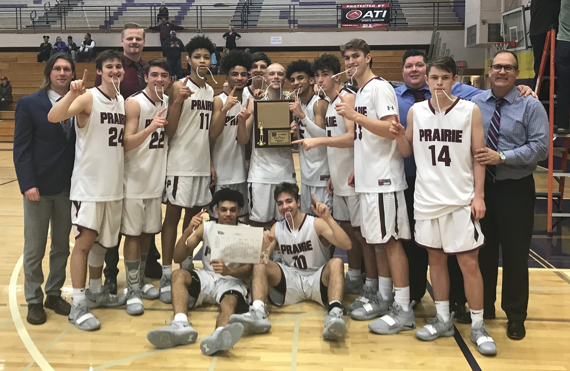 The Prairie boys basketball team celebrates its 3A bi-district tournament championship after beating Kelso 66-62 on Saturday, Feb. 16, 2019, at Puyallup High School.