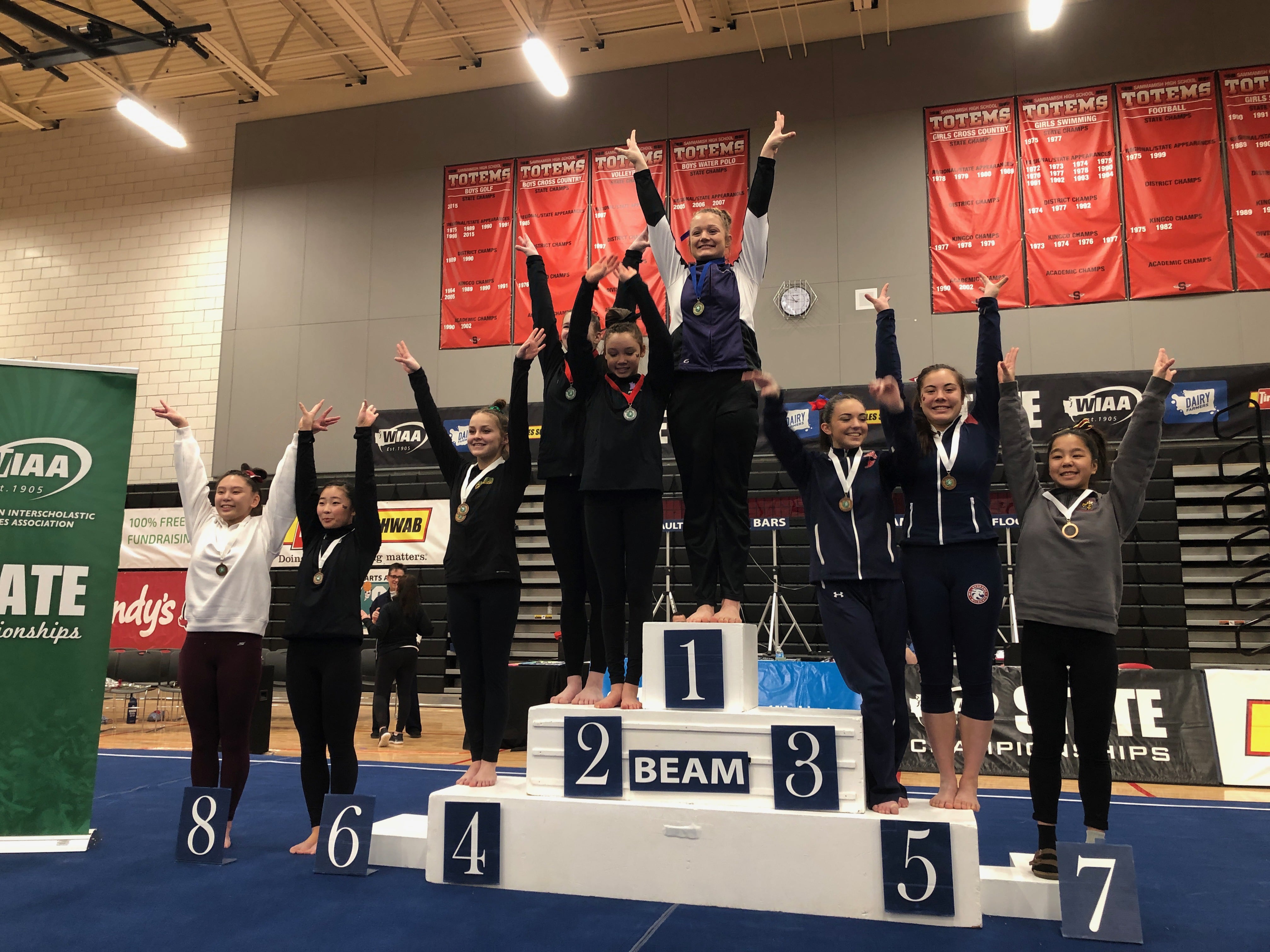 Columbia River's Grace Gordan stands atop the podium after winning a state championship on the balance beam at the 3A/2A/1A state gymnastics championship in Bellevue on Friday (Andy Buhler/The Columbian)