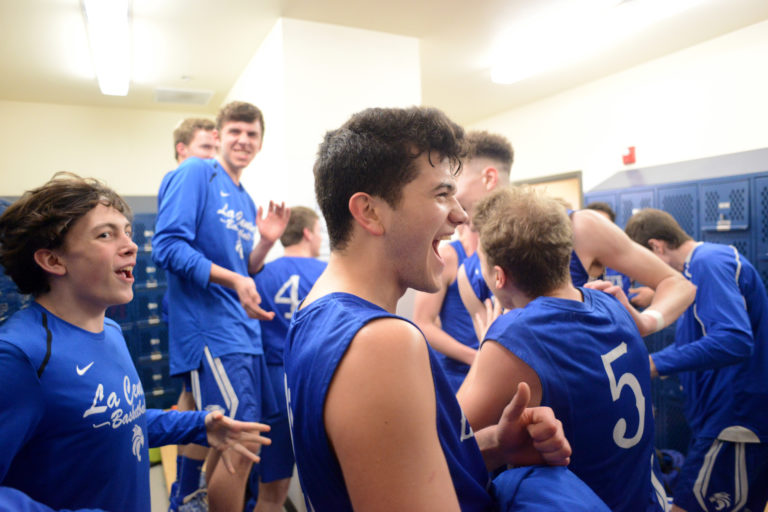 The La Center boys basketball team celebrates after beating King's Way at King's Way Christian School in Vancouver on Friday, February 1, 2019. King's Way beat La Center 67-65 in overtime.