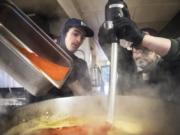 Mitchell Silagy, left, and Dave Silagy add spices to a habanero sauce while working in the kitchen of The Cedars at Salmon Creek golf course in Brush Prairie.