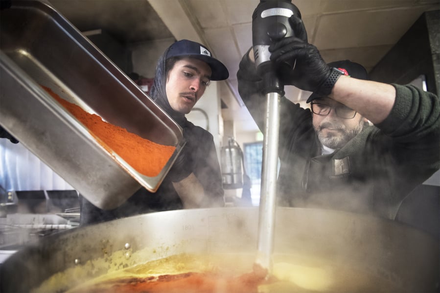 Mitchell Silagy, left, and Dave Silagy add spices to a habanero sauce while working in the kitchen of The Cedars at Salmon Creek golf course in Brush Prairie.