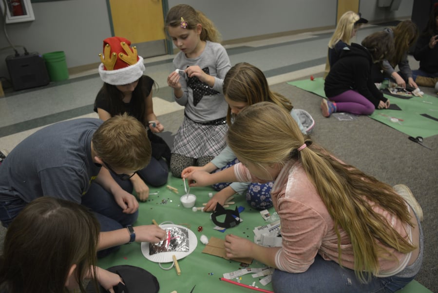 Cape Horn-Skye Elementary School students Wyatt Taylor, from left. Alyssa Jackson, Amelia Volosenco, Claire Taylor work on knight-themed crafts during a Battle of the Books tournament.