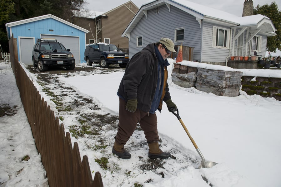 Paul Yates of Camas shovels his driveway Sunday before the workweek.