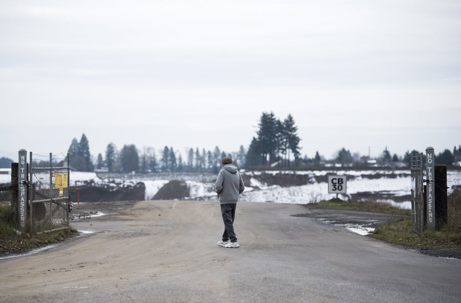 Mike Nelson of Vancouver walks to the entrance of the Section 30 gravel-mining site to get a better look. Residents near the site have raised concerns about a proposed compost facility that would operate inside this mining pit in east Vancouver.