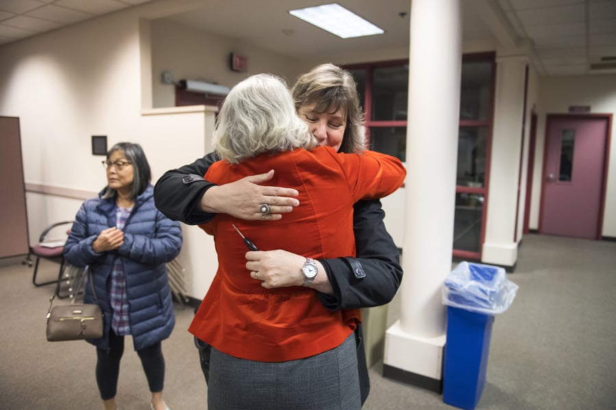 Tamara Shoup, interim executive director for school supports, center left, and Christina Iremonger, chief digital officer, hug in celebration after hearing election results at the Vancouver Public Schools district offices on Tuesday night. Both the educational fund and technology levies were passing with wide margins after initial results were released.