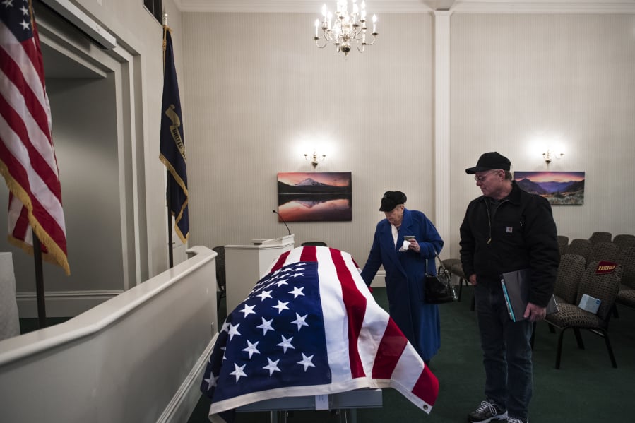 Carole Green, sister of U.S. Navy Musician Second Class Francis E. Dick, and her son, Mike Green, stand with Dick’s casket at Vancouver Funeral Chapel after meeting his body at Portland International Airport on Feb. 9. Green last saw her brother when she was 3 years old.