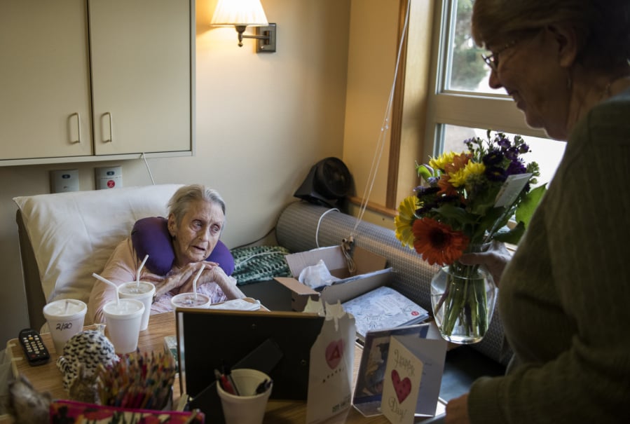 Ray Hickey Hospice House resident Mary Lou Jensen, left, thanks PeaceHealth hospice volunteer Kathi Anderson of Vancouver as Anderson delivers her flowers from the Portland-based The Bloom Project at the hospice home in Vancouver. “In a place where people are sad or not doing well, it’s a bright spot,” Anderson said.