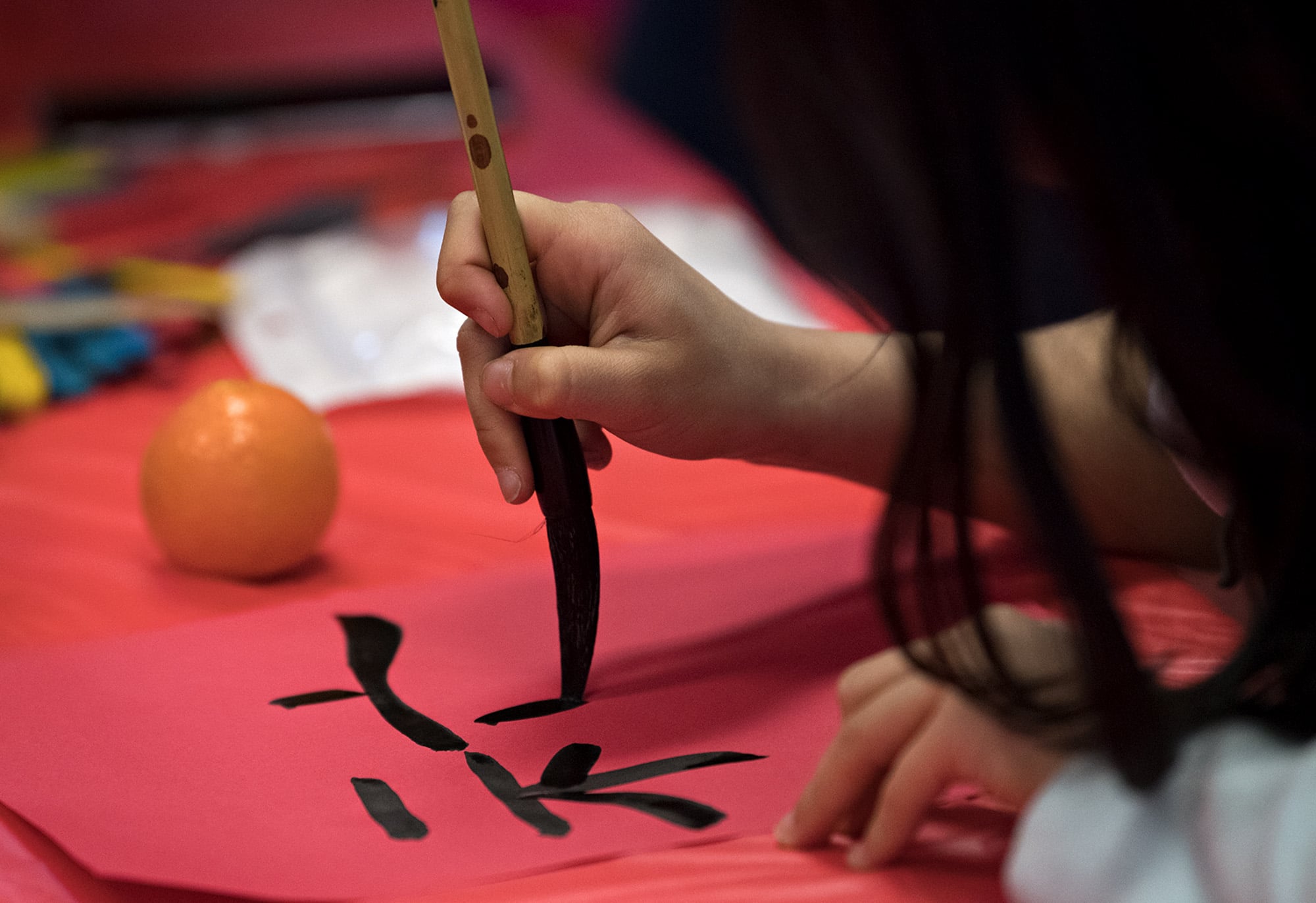 A young participant practices her calligraphy during the Lunar New Year celebration at Washington State University Vancouver on Wednesday afternoon, Feb. 20, 2019.