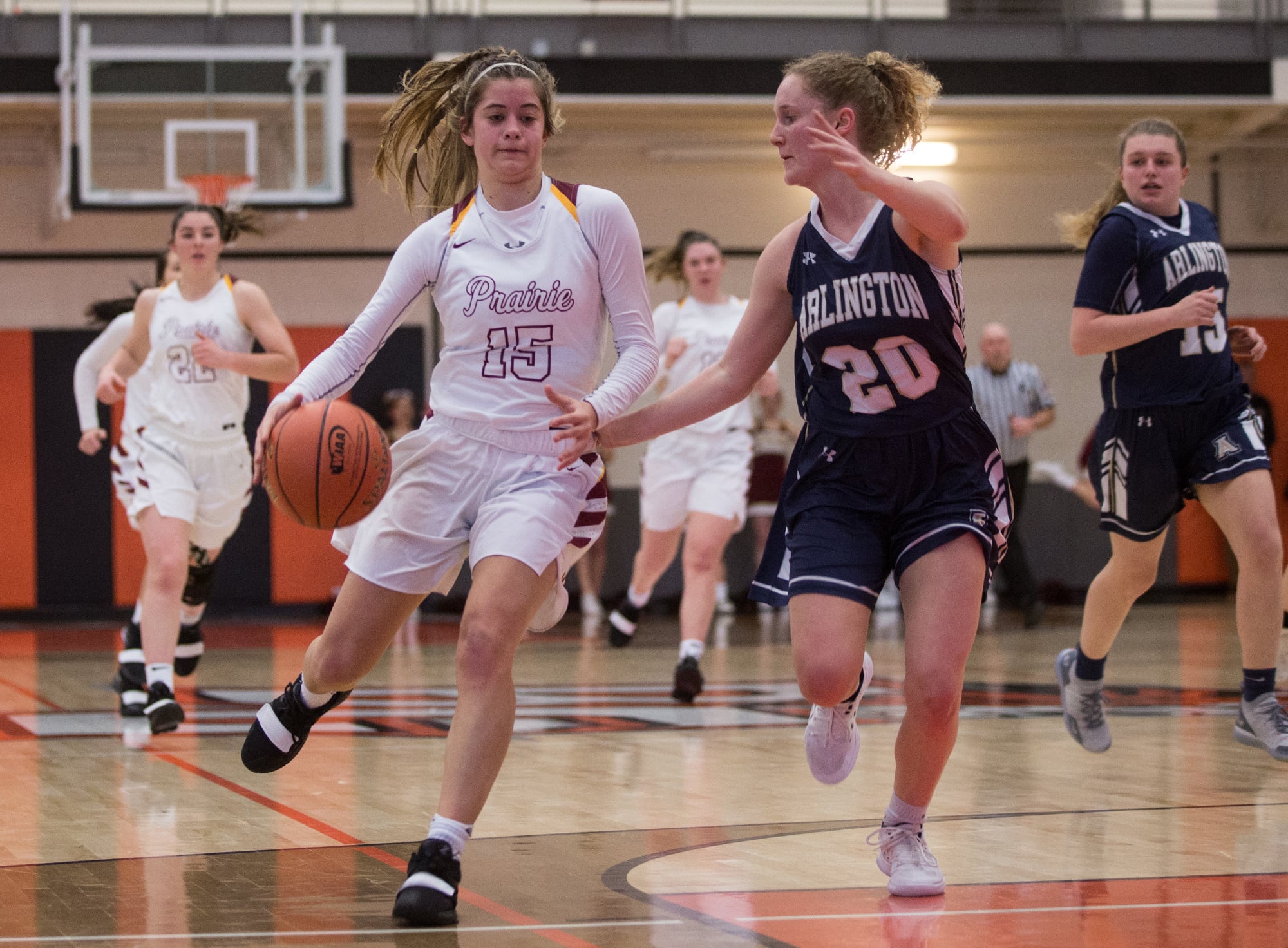 Prairie's Cassidy Gardner (15) attempts to dribble past Arlington's Sierra Scheppele (20) during the first half of a 3A regional basketball game at Battle Ground High School, Saturday, Feb. 23, 2019. Prairie went on to defeat Arlington 55-46.