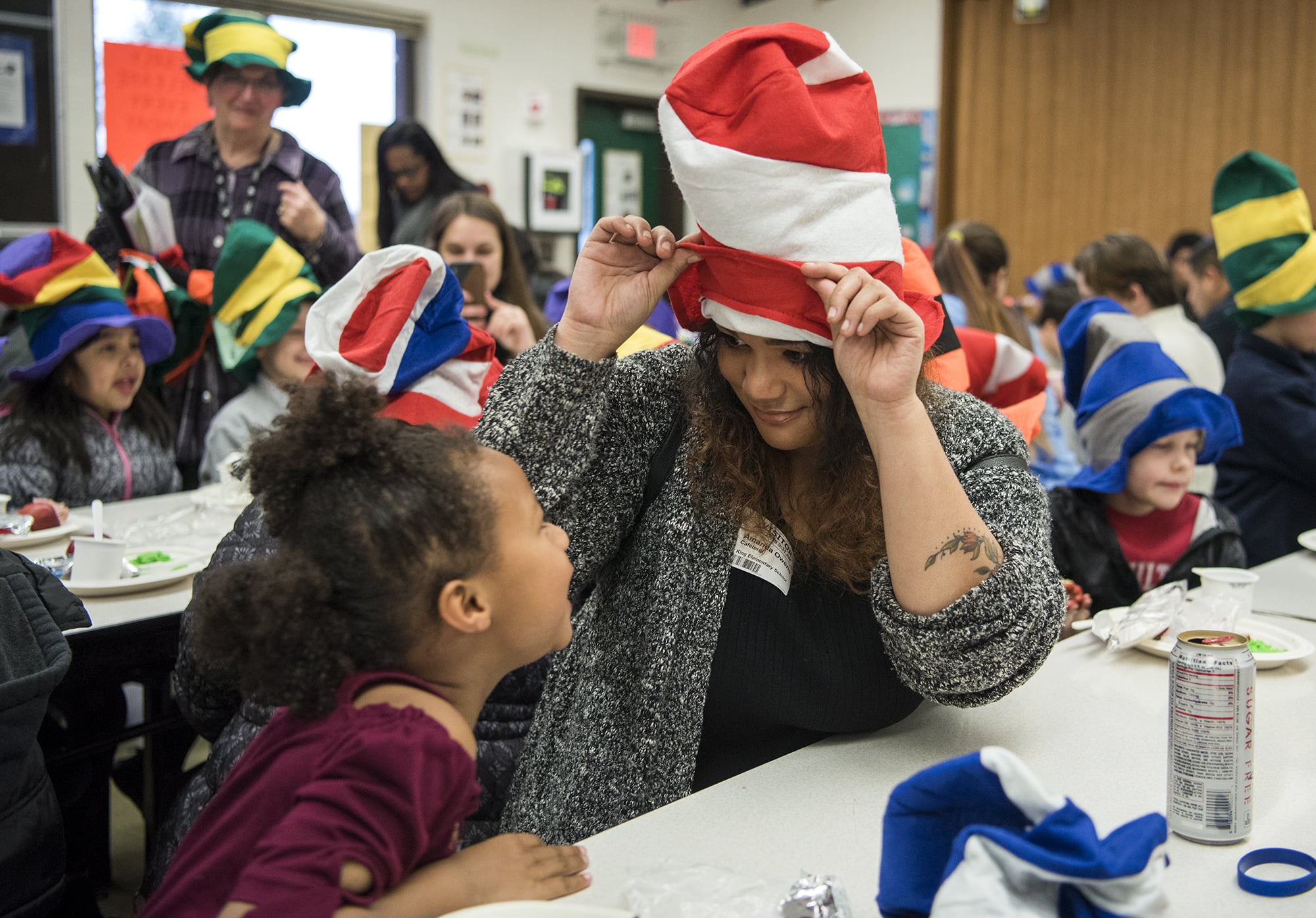 Martin Luther King Elementary School first-grader Nyah Owens, left, and her mother, Amanda Owens, goof around with their Dr. Seuss hat at the elementary school in Vancouver on Wednesday morning.