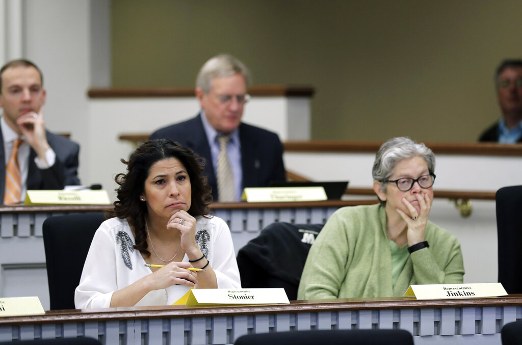 Rep. Monica Stonier, D-Vancouver, lower left, and Rep. Laurie Jenkins, D-Tacoma, right, listen Friday, Feb. 8, 2019, during a public hearing before the House Health Care &amp; Wellness Committee at the Capitol in Olympia, Wash. Amid a measles outbreak that has sickened people in Washington state and Oregon, lawmakers heard public testimony Friday on a bill that would remove parents' ability to claim a philosophical exemption to opt their school-age children out of the combined measles, mumps and rubella vaccine. (AP Photo/Ted S.