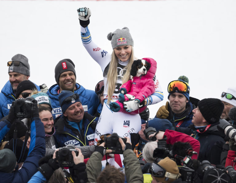 Lindsey Vonn of the United States celebrates with the dog Lucy after the flower ceremony of the women downhill race at the 2019 FIS Alpine Skiing World Championships in Are, Sweden Sunday, Feb. 10, 2019.