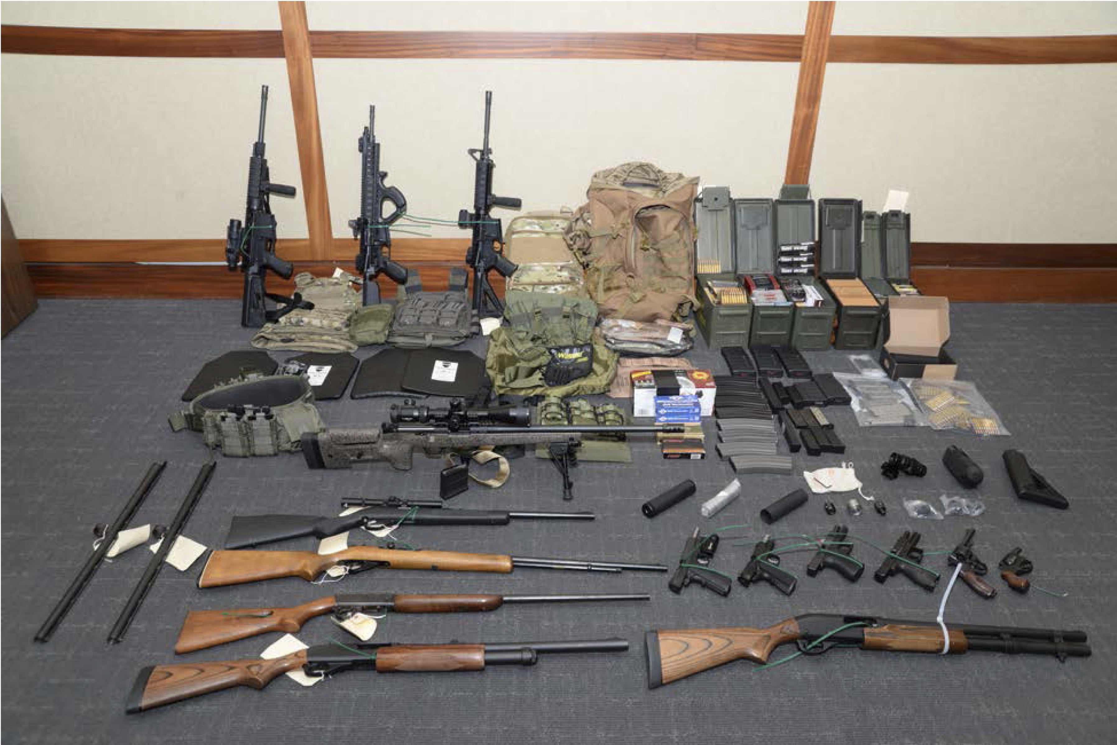 This image provided by the U.S. District Court in Maryland shows a photo of firearms and ammunition that was in the motion for detention pending trial in the case against Christopher Paul Hasson. Prosecutors say that Hasson, a Coast Guard lieutenant is a "domestic terrorist" who wrote about biological attacks and had a hit list that included prominent Democrats and media figures. He is due in court on Feb. 21 in Maryland. Prosecutors say Hasson espoused extremist views for years. Court papers say Hasson described an "interesting idea" in a 2017 draft email that included "biological attacks followed by attack on food supply." (U.S.