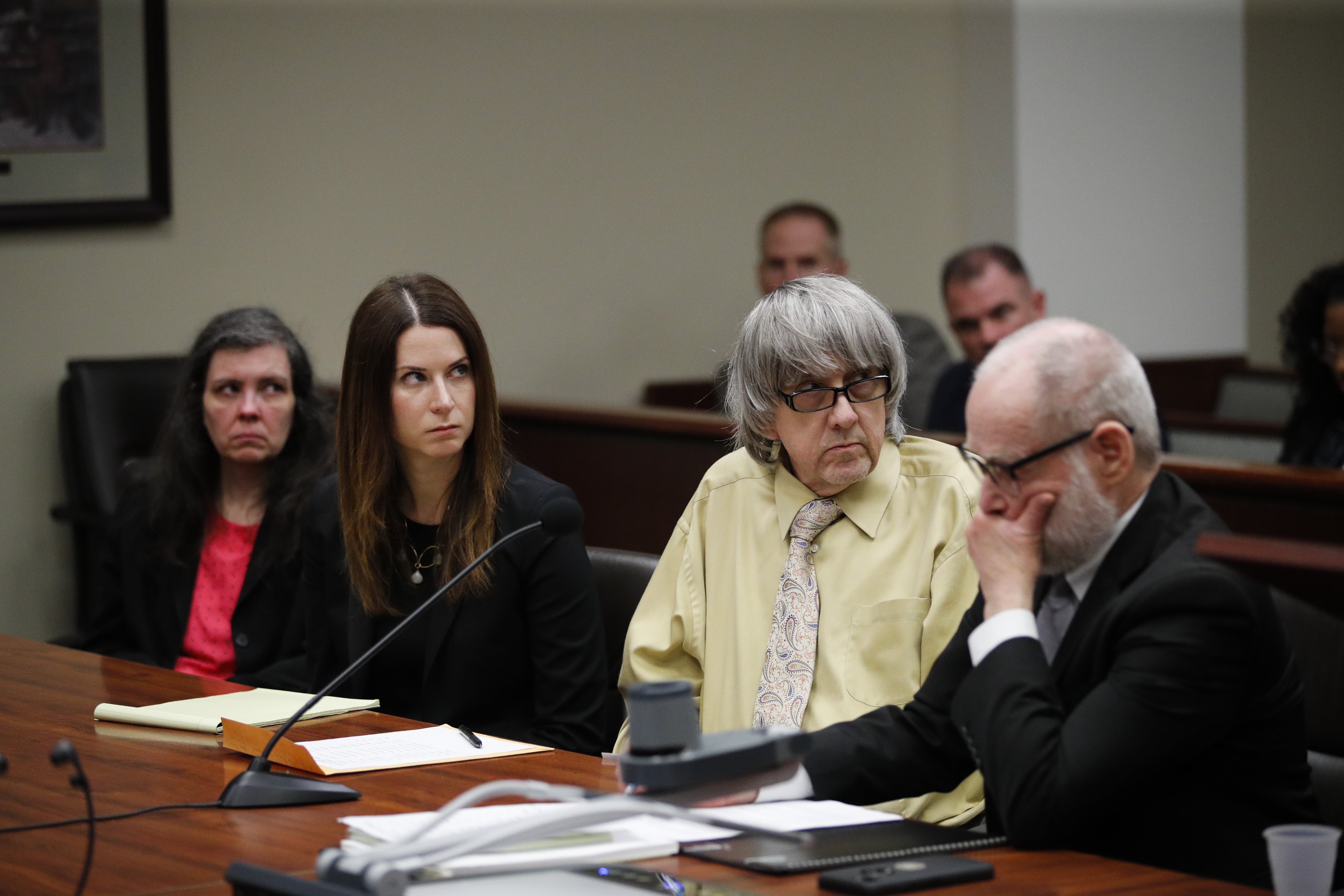 David Turpin, second from right, and wife, Louise, far left, listen to their charges as they are joined by their attorneys, Allison Lowe, second from left, and David Macher during a courtroom hearing, Friday, Feb. 22, 2019, in Riverside, Calif. The California couple who shackled some of their 13 children to beds and starved them pleaded guilty Friday to torture and other abuse in a case dubbed a "house of horrors." (AP Photo/Jae C.