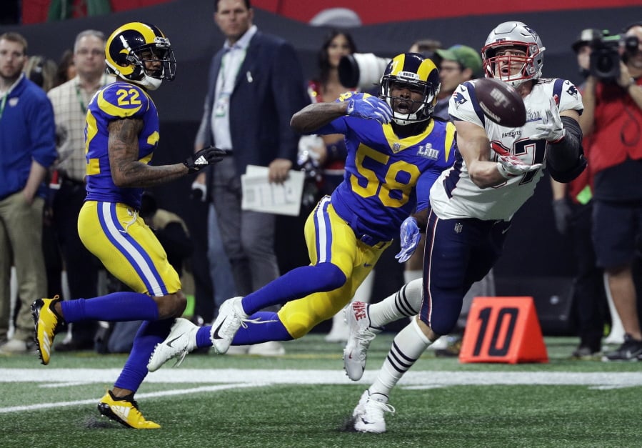 New England Patriots’ Rob Gronkowski (87) catches a pass in front of Los Angeles Rams’ Marcus Peters (22) and Cory Littleton (58) during the second half of the NFL Super Bowl 53 football game Sunday, Feb. 3, 2019, in Atlanta. (AP Photo/David J.