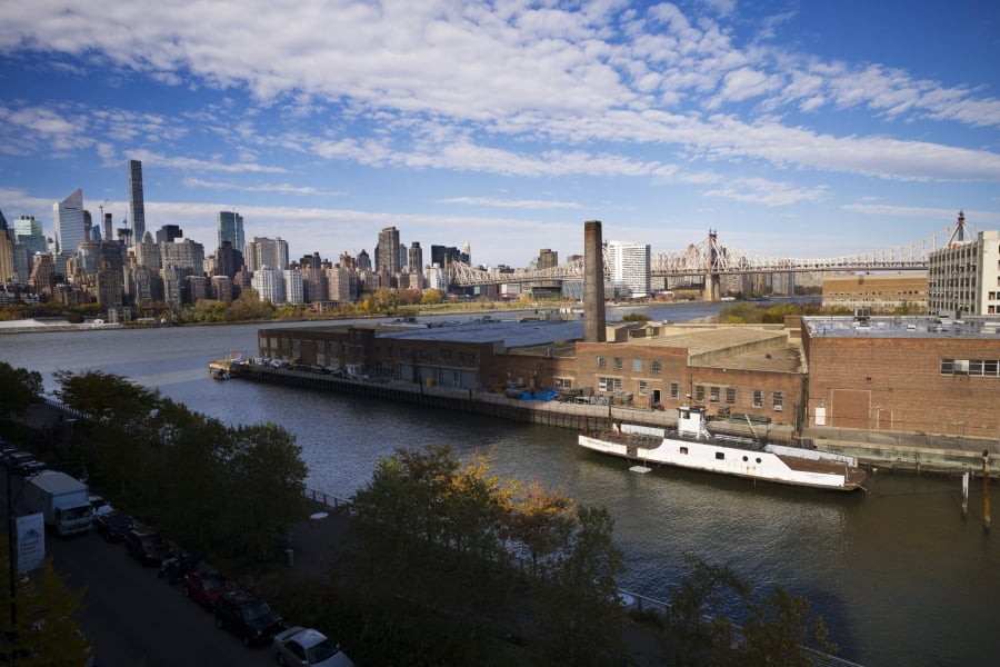 FILE- In this Nov. 7, 2018, file photo, a rusting ferryboat is docked next to an aging industrial warehouse on Long Island City’s Anable Basin in the Queens borough of New York. Amazon said Thursday, Feb. 14, 2019, that it will not be building a new headquarters in New York, a stunning reversal after a yearlong search.