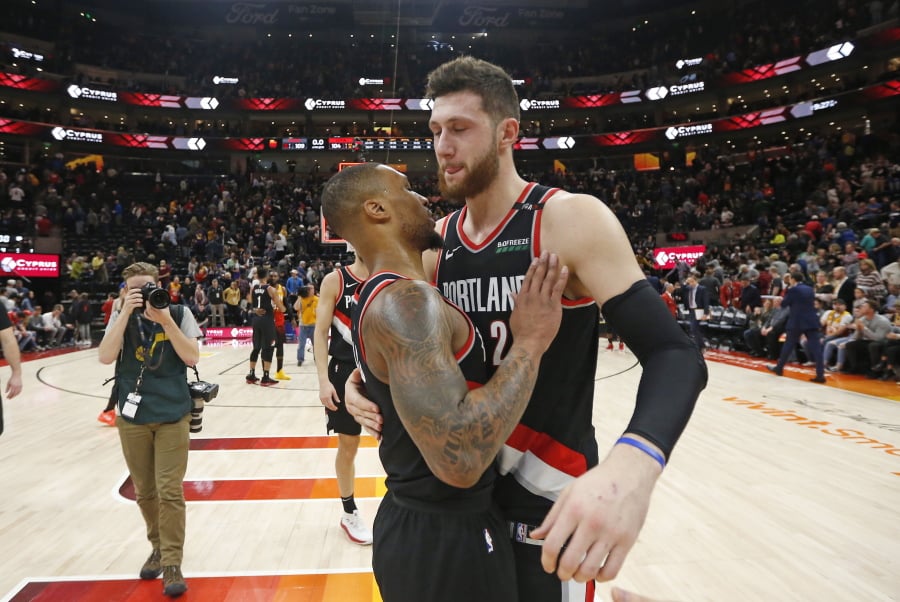 FILE - In this Jan. 21, 2019, file photo, Portland Trail Blazers’ Damian Lillard, left, and Jusuf Nurkic celebrate following their victory against the Utah Jazz in an NBA basketball game in Salt Lake City. Portland resumes its season on Thursday at the Brooklyn Nets. It will likely mark the Blazers debut of Enes Kanter, signed just before the break.