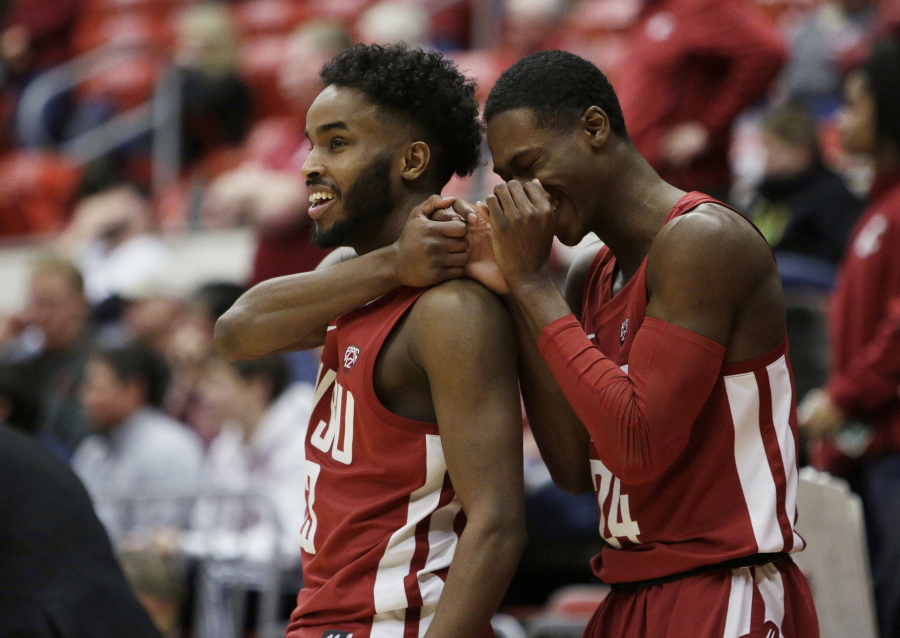 Washington State guard Ahmed Ali, left, and guard Viont'e Daniels celebrate during the second half of the team's NCAA college basketball game against Colorado in Pullman, Wash., Wednesday, Feb. 20, 2019. Washington State won 76-74.