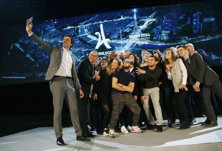 Paris 2024 Games’ chief Tony Estanguet, left, makes a selfie with all invited guests after a media conference at La Defense business district, outside Paris, Thursday, Feb. 21 , 2019. The organizers of the 2024 Paris Olympics want to add breakdancing to the games, which would be a first for the dance sport that came from the streets of New York. Also on Paris’ wish-list of events it wants to add to the program are climbing, surfing and skateboarding.
