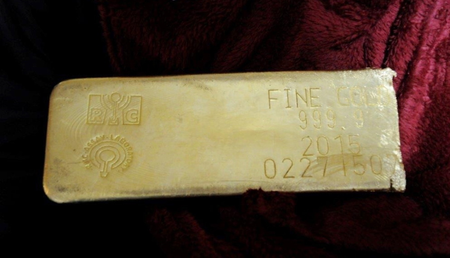 FILE- This undated file photo provided by the FBI shows a gold bar that was recovered in Miami from a heist in North Carolina on March 1, 2015. Federal prosecutors have formally charged a fugitive in the 2015 robbery of a tractor-trailer carrying almost $5 million in gold bars. U.S. Attorney’s Office in Miami announced Thursday, Feb. 7, 2019, that Pedro Santamaria has been indicted on robbery and gun charges. Authorities say he joined Adalberto Perez and Roberto Cabrera in the heist. The other two were sentenced to lengthy prison terms.