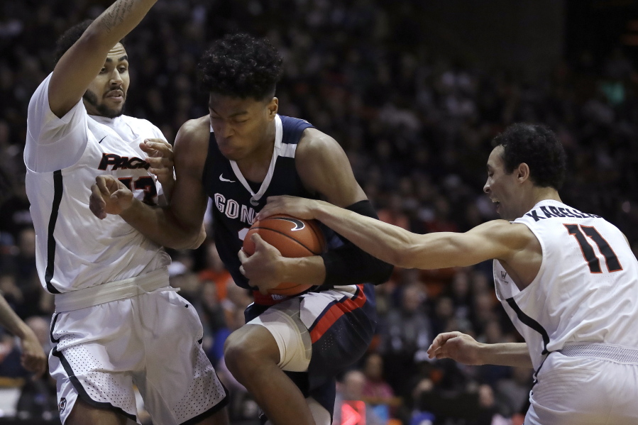 Gonzaga’s Rui Hachimura, center, drives the ball between Pacific’s Jeremiah Bailey, left, and Khy Kabellis during the first half of an NCAA college basketball game Thursday, Feb. 28, 2019, in Stockton, Calif.