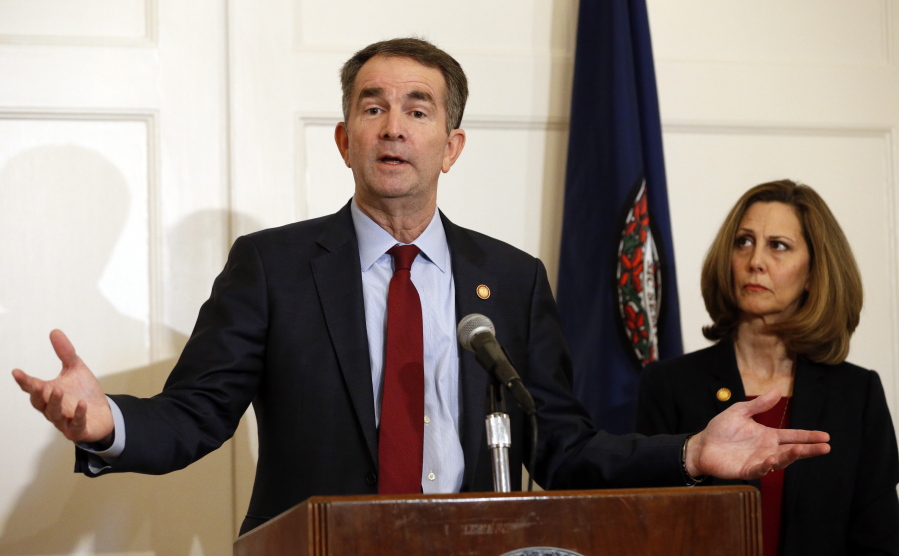 Virginia Gov. Ralph Northam, left, accompanied by his wife, Pam, speaks during a news conference in the Governor’s Mansion in Richmond, Va., on Saturday, Feb. 2, 2019. Resisting widespread calls for his resignation, Northam on Saturday vowed to remain in office after disavowing a racist photograph that appeared under his name in his 1984 medical school yearbook.