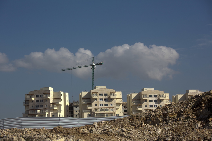 FILE - In this Jan. 1, 2019 file photo, a new housing project is seen in the West Bank settlement of Modiin Ilit. A West Bank settler group said in a report issued Tuesday, Feb. 5, 2019, that the number of people living in Israeli Jewish settlements surged at a much faster rate than the overall Israeli population last year. Baruch Gordon, director of West Bank Jewish Population Stats, is predicting an even faster growth rate in the coming years, thanks to what he says is a friendly environment under the Trump administration.