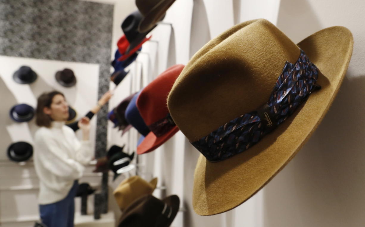 A woman looks at hats Jan. 16 in a Borsalino store in downtown Milan, Italy. If the traditional Italian hat-maker Borsalino was once synonymous with the fedora, its new private equity owners want to imbue the brand with cachet that extends to couture, sportswear and streetwear for women and Millennials — without alienating its classic customers and the silhouette that helped shape the rough-and-tumble images of Robert Redford, Frank Sinatra and, perhaps no one more than, Humphrey Bogart.
