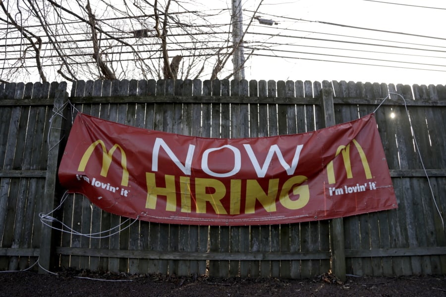 An employment sign hangs from a wooden fence on the property of a McDonald’s restaurant Jan. 3 in Atlantic Highlands, N.J.