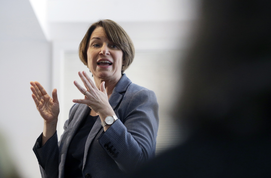 In this Sunday, Feb. 24, 2019, photo, U.S. Sen. Amy Klobuchar, D-Minn., speaks to voters during a campaign stop at a home in Nashua, N.H. U.S. Sen. and presidential hopeful Klobuchar has built a reputation as an effective champion for consumer safety. She also aggressively advocated for the medical device industry - a big employer in her home state of Minnesota - in ways that complicate her reputation as a consumer defender. Some consumer advocates say her work has helped put patients at risk.
