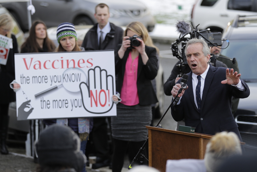 Robert Kennedy Jr., right, speaks at a rally held in opposition to a proposed bill that would remove parents’ ability to claim a philosophical exemption to opt their school-age children out of the combined measles, mumps and rubella vaccine, Friday, Feb. 8, 2019, at the Capitol in Olympia, Wash. Amid a measles outbreak that has sickened people in Washington state and Oregon, lawmakers earlier Friday heard public testimony on the bill. (AP Photo/Ted S.