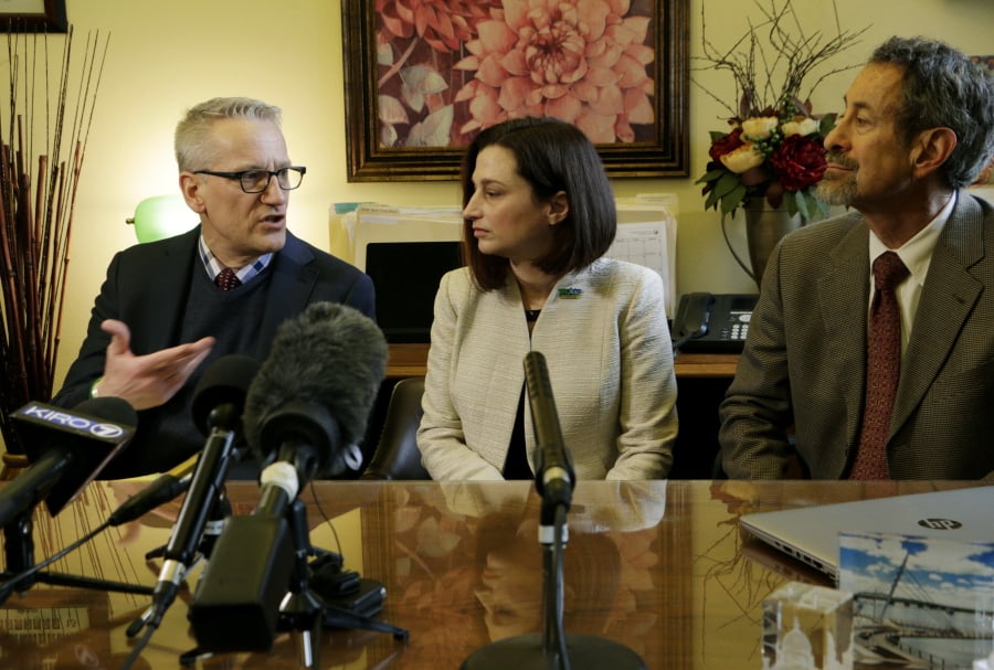 Department of Health Secretary John Wiesman, left, talks to the media as Dr. Robyn Rogers, center, and Dr. Gary Goldbaum of the Washington State Medical Association look on, on Wednesday, Feb. 20, 2019, in Olympia, Wash. Lawmakers are considering two measures, one that would remove the exemption from the combined measles, mumps and rubella vaccine, and another that would not allow personal or philosophical exemptions to be granted for any required school vaccinations.