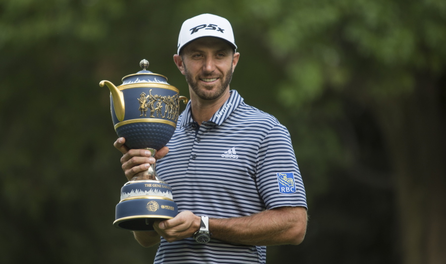 U.S. golfer Dustin Johnson poses with his Mexico Championship trophy at the Chapultepec Golf Club in Mexico City, Sunday, Feb. 24, 2019.