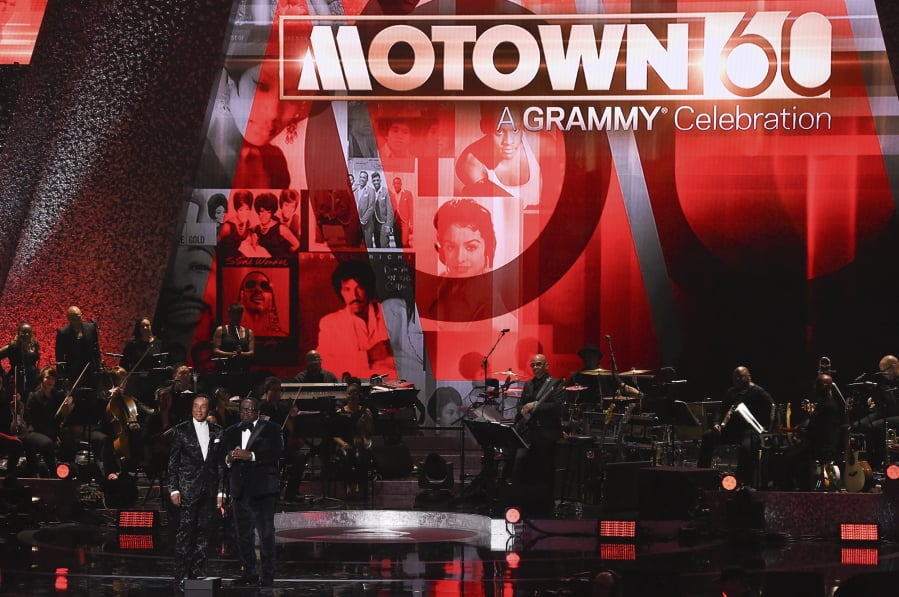 Smokey Robinson, left, and Cedric the Entertainer speak onstage during “Motown 60: A Grammy Celebration”.