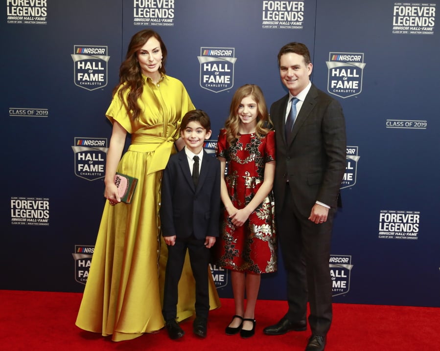 Former NASCAR driver Jeff Gordon, right, and his family from left: Ingrid Vandebosch, son Leo Benjamin and daughter Ella Sofia pose for photos before the NASCAR Hall of Fame induction ceremony for the Class of 2019, Friday, Feb. 1, 2019, in Charlotte, N.C. (AP Photo/Jason E.