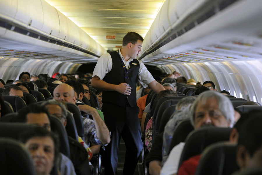 FILE- In this May 9, 2013, file photo, Allegiant Air flight attendant Chris Killian prepares his passengers for the Laredo, Tex, bound flight before it pushes back from the terminal at McCarran International Airport in Las Vegas. Smaller-company stocks like Allegiant Travel and Shutterfly have been soaring since late December and leading the rest of the market, a sharp reversal from much of the winter, when smaller stocks were plunging more than the rest of the market.