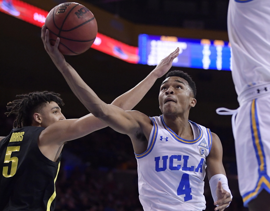 UCLA guard Jaylen Hands, right, shoots as Oregon forward Miles Norris defends during the second half of an NCAA college basketball game Saturday, Feb. 23, 2019, in Los Angeles. UCLA won 90-83. (AP Photo/Mark J.