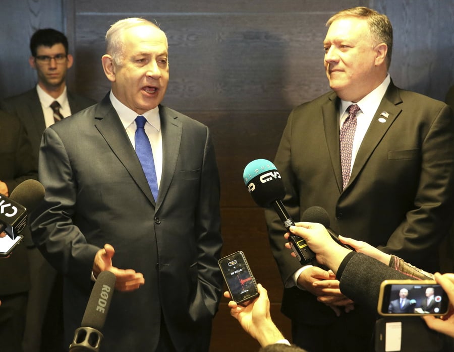 Israeli Prime Minister Benjamin Netanyahu, left, and US Secretary of State Mike Pompeo, right, talk to the press on the sidelines of a session at the conference on Peace and Security in the Middle East in Warsaw, Poland, Thursday, Feb. 14, 2019.