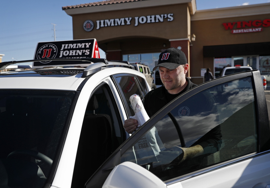 Tyler Schwecke, a delivery driver for Jimmy John’s, gets in his car Wednesday to make a delivery in Las Vegas. Last week, Jimmy John’s sandwich chain launched a national ad campaign promising never to use third-party delivery.