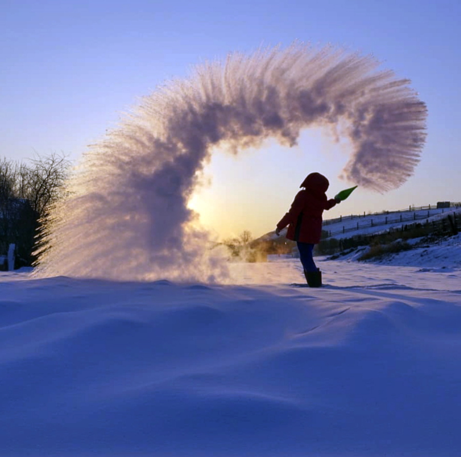In this handout photo taken on Tuesday, Feb. 5, 2019, a woman throws boiling water into the freezing air as its instantly condenses into an elaborate pattern of ice crystals in Irkutsk, Russia . Residents of Russia’s Urals and Siberia where temperatures recently plunged to minus 40 degrees Fahrenheit have taken to social media to celebrate the cold. Temperatures in Siberia and the Urals earlier this week plunged to around minus 40 degrees Centigrade (minus 40 degrees Fahrenheit) which is unusually low even for the cold-resistant Russians.