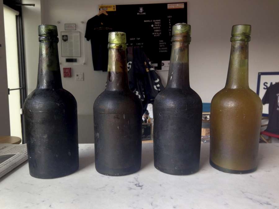 Four bottles recovered from the SS Oregon, a 133-year-old shipwreck, are shown in 2017 at the Saint James Brewery in Holbrook, N.Y.