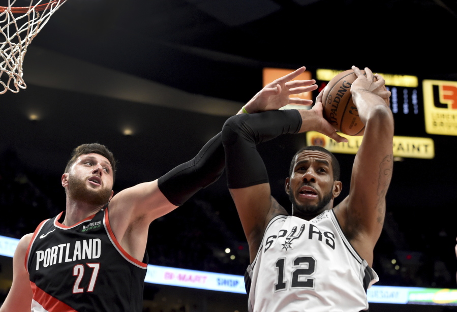 San Antonio Spurs center LaMarcus Aldridge, right, grabs a rebound in front of Portland Trail Blazers center Jusuf Nurkic during the first half of an NBA basketball game in Portland, Ore., Thursday, Feb. 7, 2019.
