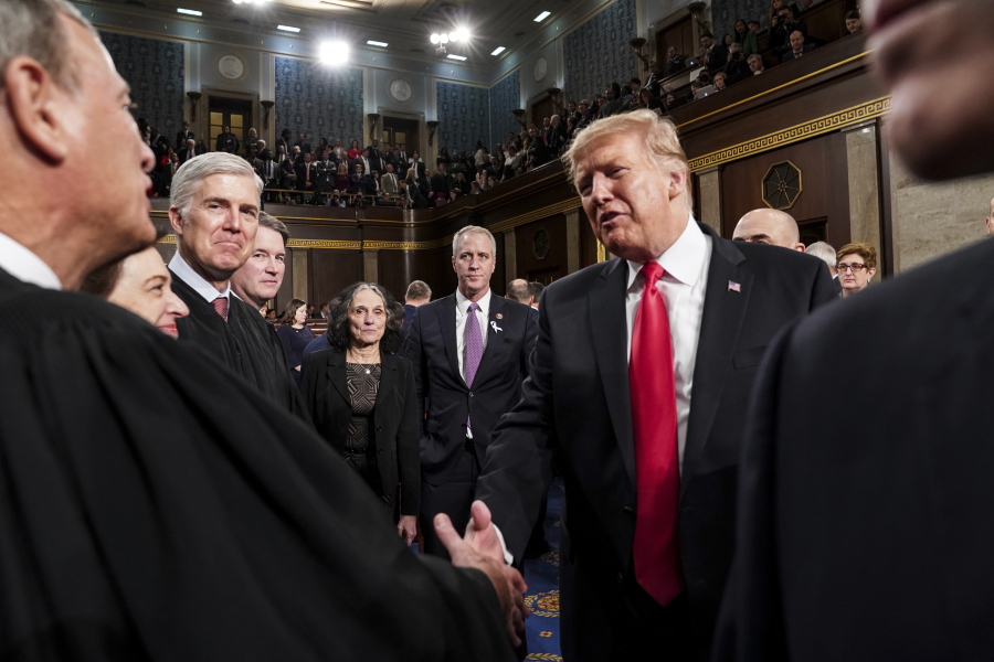 President Donald Trump talks to Supreme Court Chief Justice John Roberts while leaving the House chamber after giving his State of the Union address to a joint session of Congress, Tuesday, Feb. 5, 2019 at the Capitol in Washington.