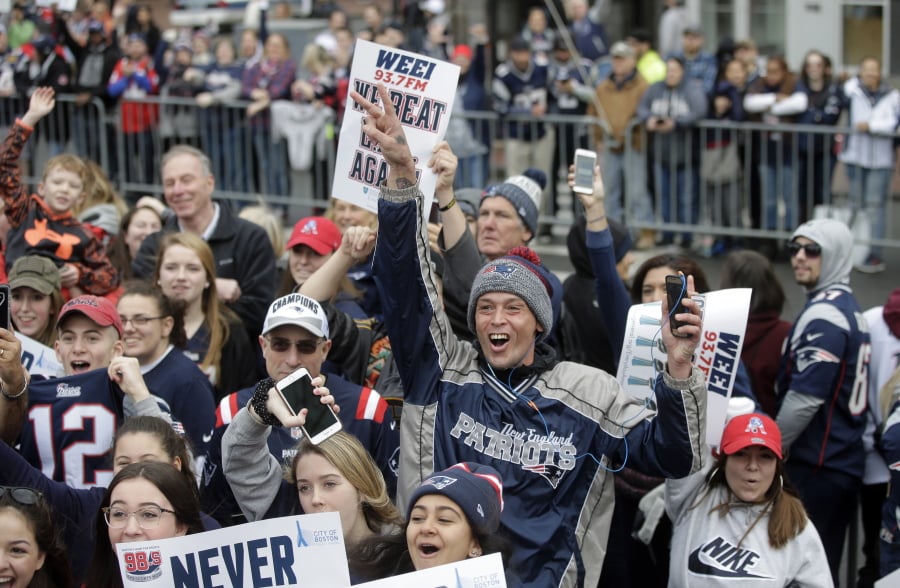Fans wait for the New England Patriots parade to through downtown Boston, Tuesday, Feb. 5, 2019, to celebrate their win over the Los Angeles Rams in Sunday’s NFL Super Bowl 53 football game in Atlanta.