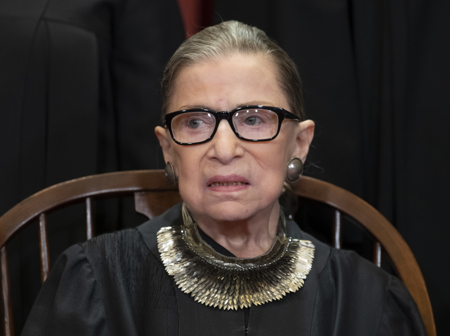 FILE - In this Nov. 30, 2018 file photo, Associate Justice Ruth Bader Ginsburg sits with fellow Supreme Court justices for a group portrait at the Supreme Court Building in Washington. Ginsburg is making her public return to the Supreme Court bench, eight weeks after surgery for lung cancer. (AP Photo/J.