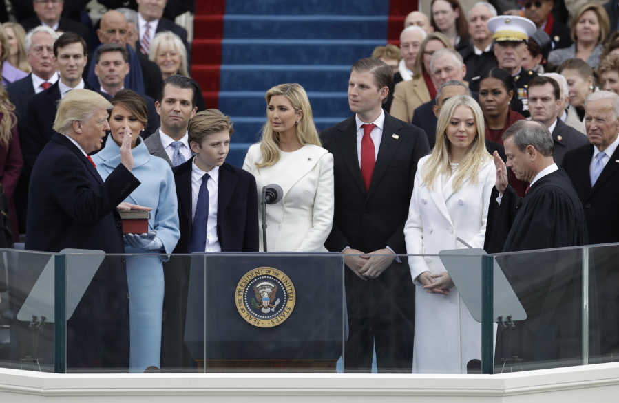 FILE - In this Jan. 20, 2017 file photo, Donald Trump, left, is sworn in as the 45th president of the United States by Chief Justice John Roberts, right, as Melania Trump, second left, and his family watch during the 58th Presidential Inauguration at the U.S. Capitol in Washington. A federal subpoena seeking documents from Donald Trump’s inaugural committee is part of “a hysteria” over the fact that he’s president, White House press secretary Sarah Sanders said on Tuesday, Feb. 5, 2019. Federal prosecutors in New York issued the subpoena on Monday, furthering a federal inquiry into a fund that has faced mounting scrutiny into how it raised and spent its money.