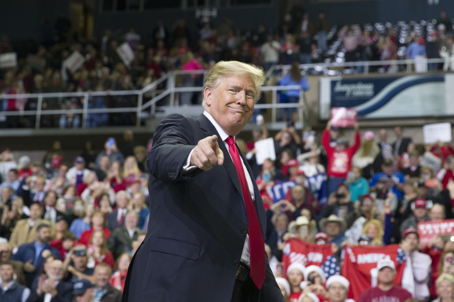 FILE - In this Nov. 26, 2018, file photo, President Donald Trump points to a supporter as he departs a rally at the Mississippi Coast Coliseum in Biloxi, Miss. President Donald Trump’s campaign has launched a state-by-state effort to prevent an intraparty fight that could spill over into the general-election campaign. The initiative includes changing state party rules, crowding out potential rivals and quelling any early signs of opposition.