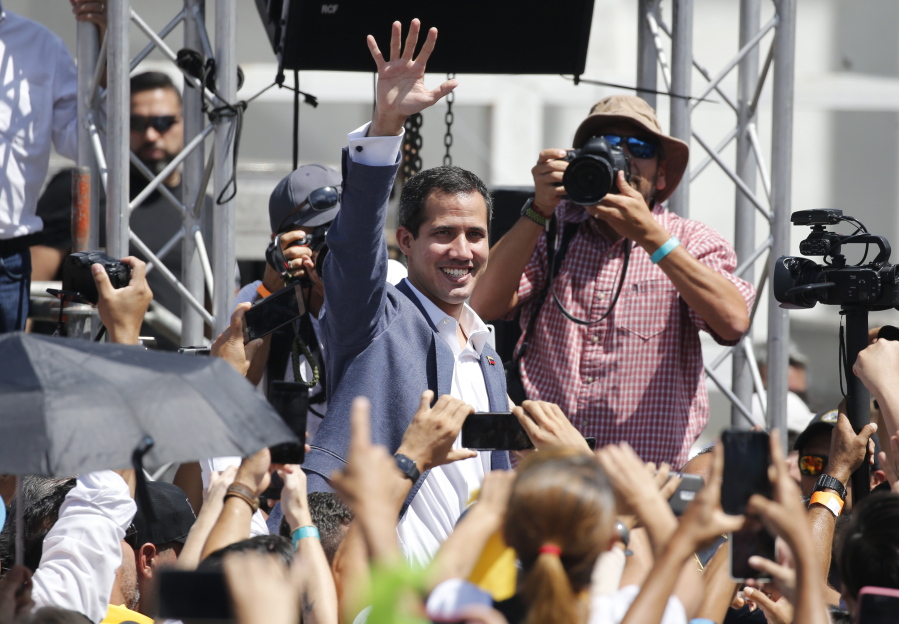 Venezuela’s self-proclaimed interim president Juan Guiado greets the crowd during an event to swear in nurses, doctors, professionals and others, as the group that will help with the arrival and distribution of humanitarian aid in Venezuela, in Caracas, Venezuela, Saturday, Feb. 16, 2019. The U.S. Air Force has begun flying tons of aid to a Colombian town on the Venezuelan border as part of an effort meant to undermine socialist President Nicolas Maduro. The first of three C-17 cargo planes has flown from Homestead Air Reserve Base in Florida and landed in the town of Cucuta.