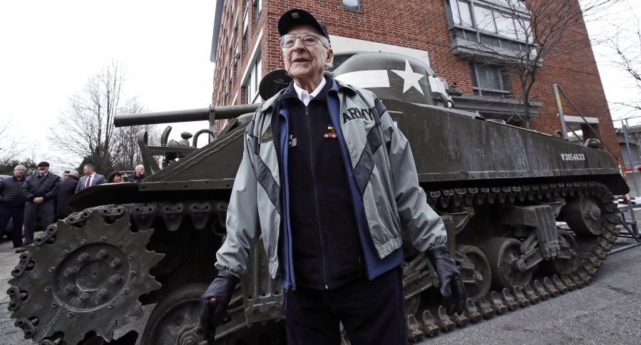 World War II tank gunner Clarence Smoyer poses for a portrait near the Charlestown Naval Shipyard in Boston, Wednesday, Feb. 20, 2019. The 95-year-old veteran was surprised with a ride through the streets of Boston in a Sherman tank, one of the tanks most widely used by the U.S. during the war.